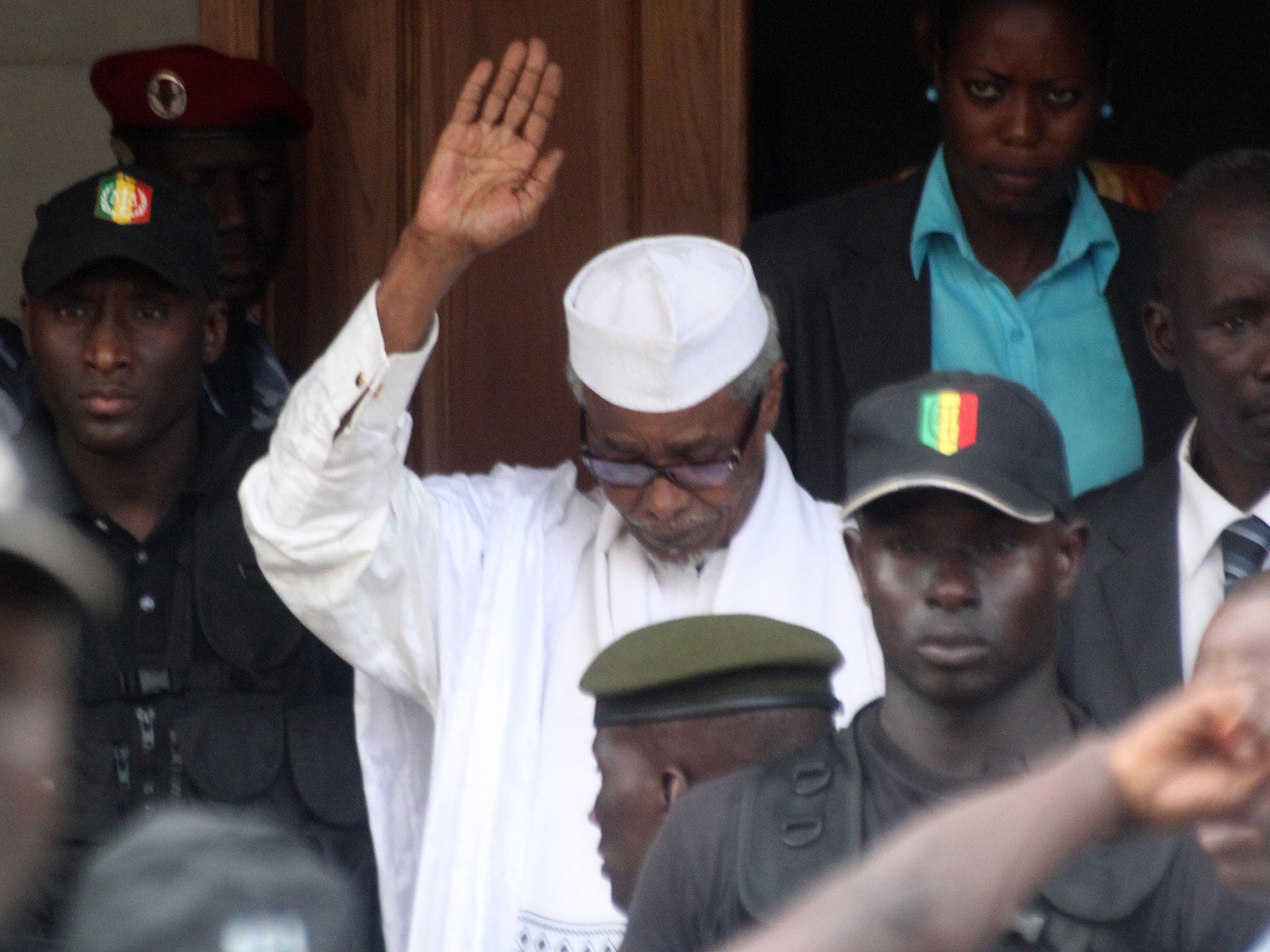 Former Chadian dictator Hissene Habre is escorted by military officers after being heard by a judge on July 2, 2013 in Dakar.