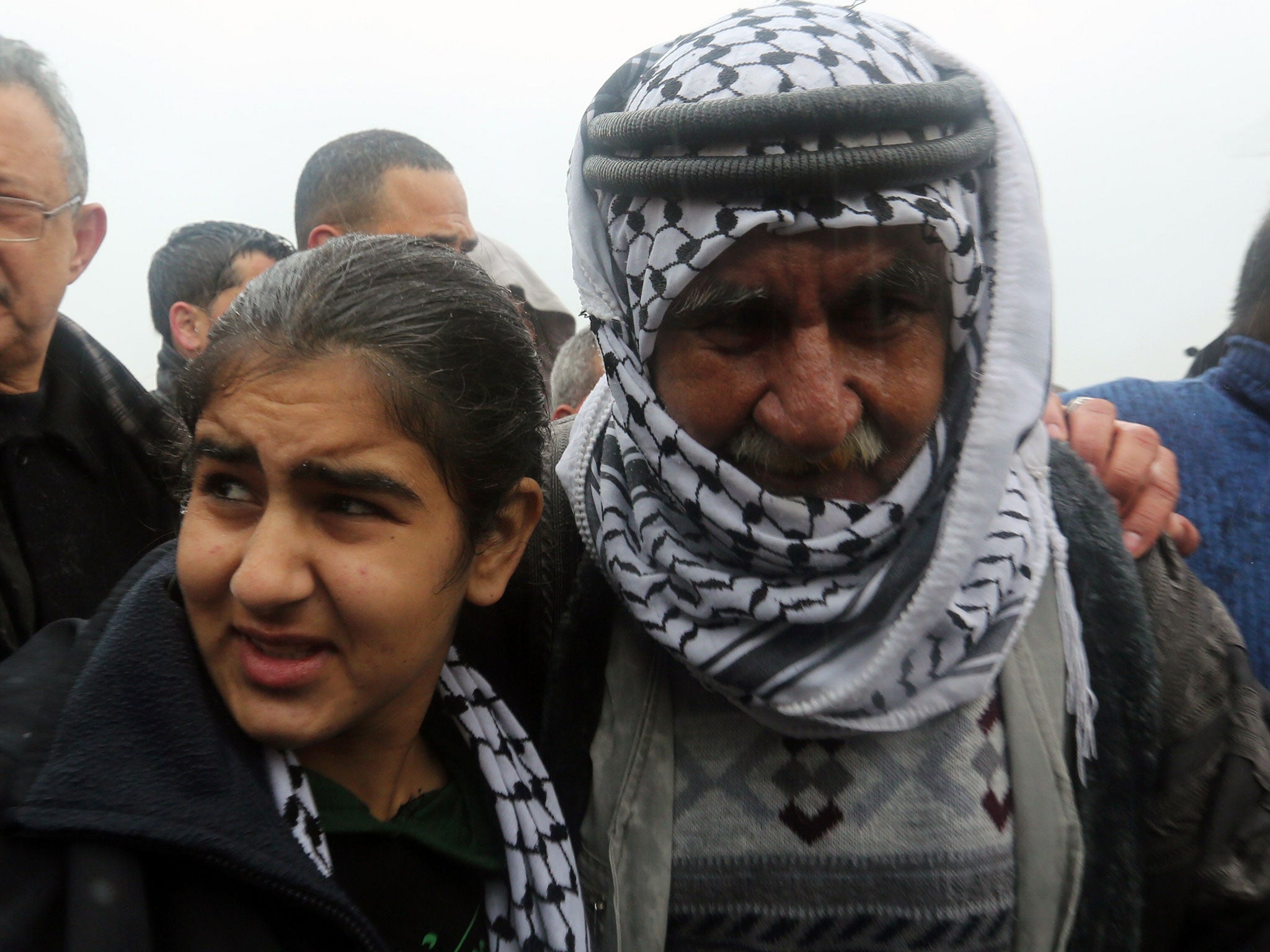 Palestinian 14-year-old Malak al-Khatib is greeted by her father after her release from an Israeli jail on February 13