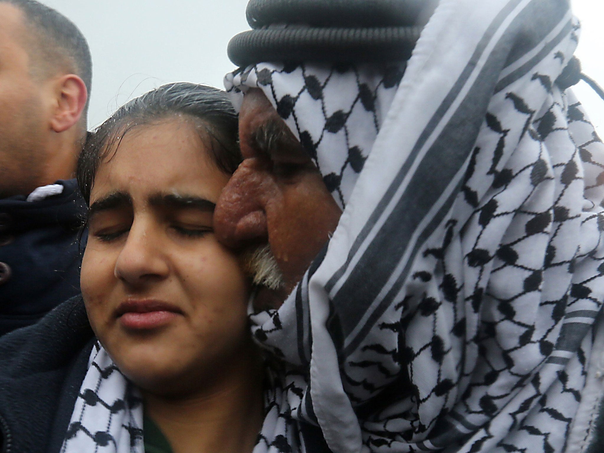 Palestinian 14-year-old schoolgirl Malak al-Khatib is greeted by her father after her release from an Israeli jail on February 13