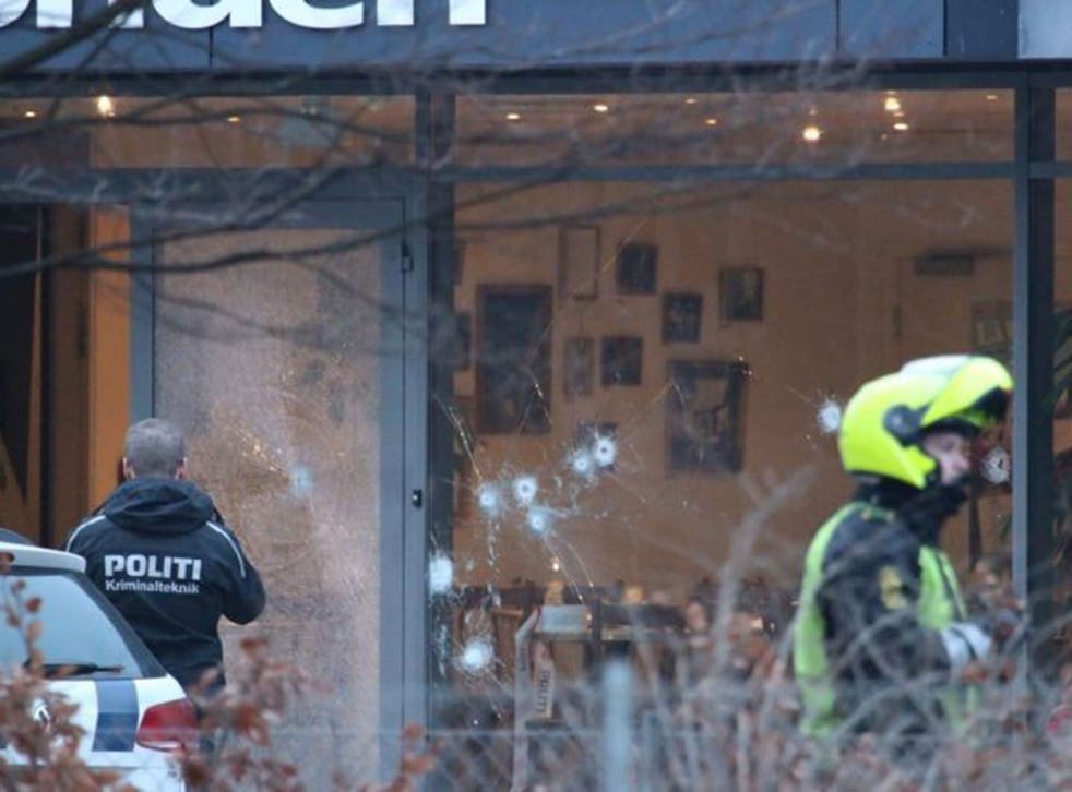 Bullet holes are seen in the window and door of Krudttonden cafe after shots were reportedly fired during a discussion meeting about art, blasphemy and free speech in Copenhagen