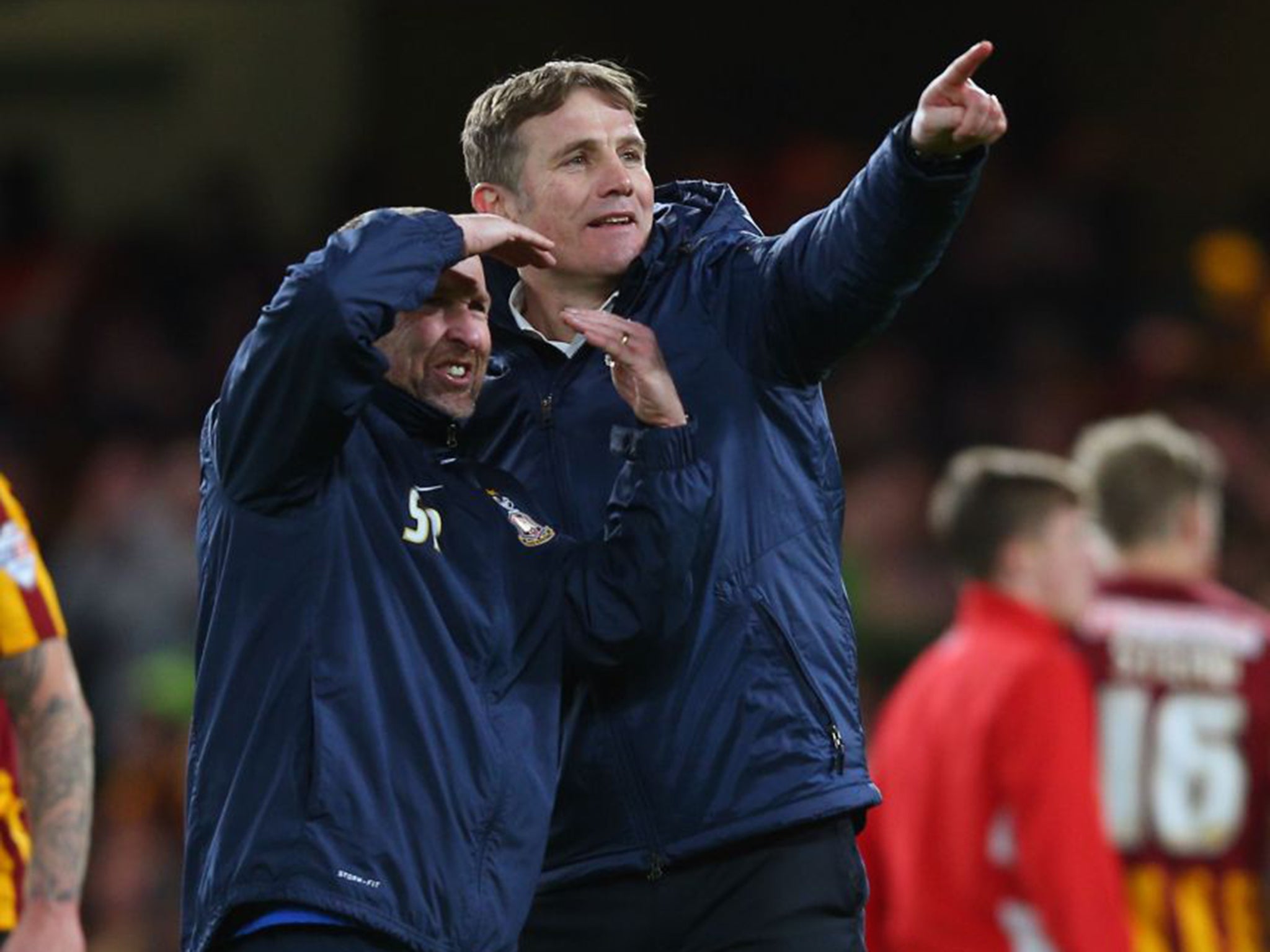 Bradford’s Phil Parkinson, right, singles out the travelling fans after beating Chelsea