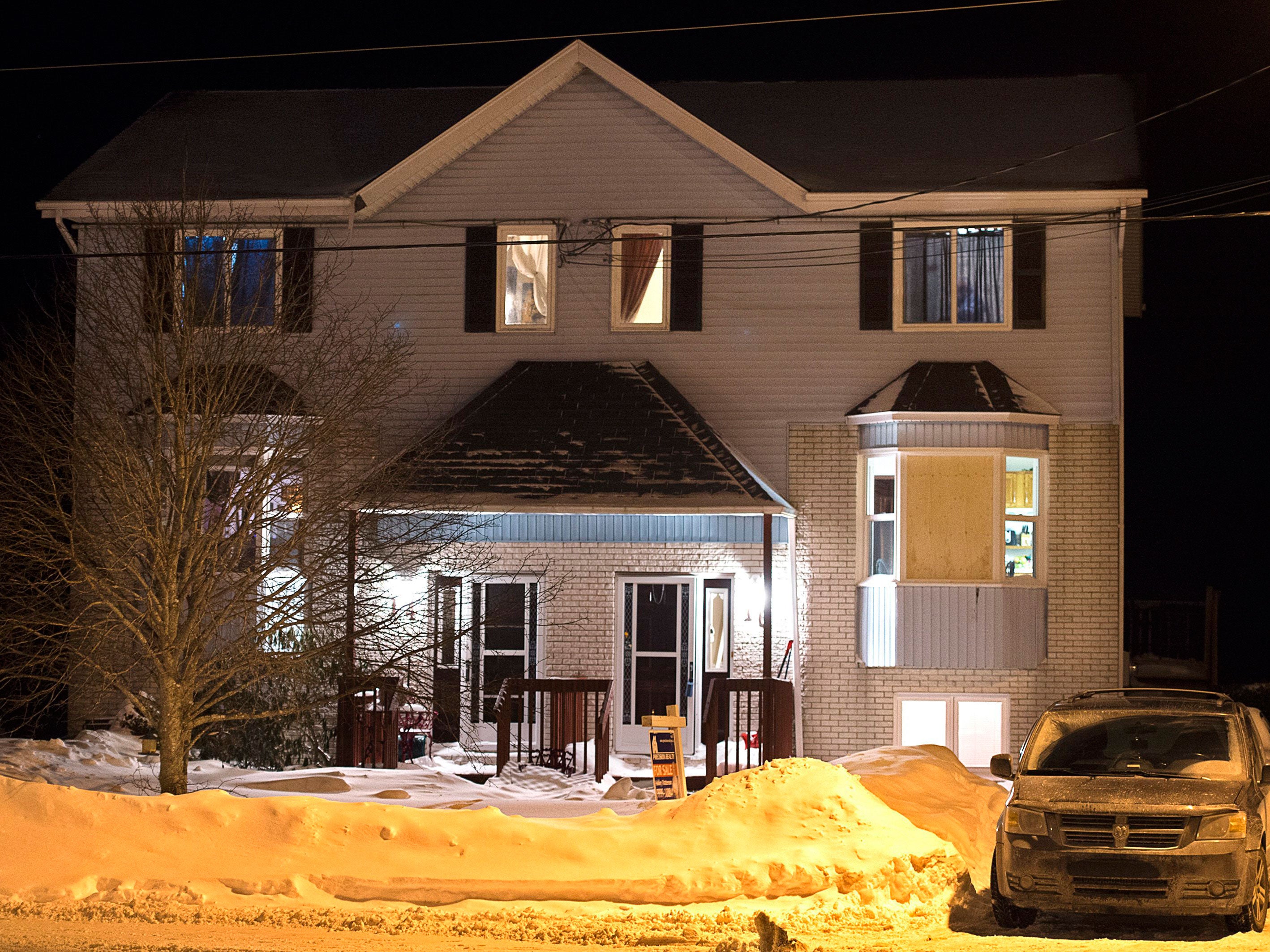 A car is parked outside a home on Tiger Maple Drive in Timberlea, Nova Scotia, a Halifax suburb, where police found a deceased person Friday, Feb. 13, 2015.