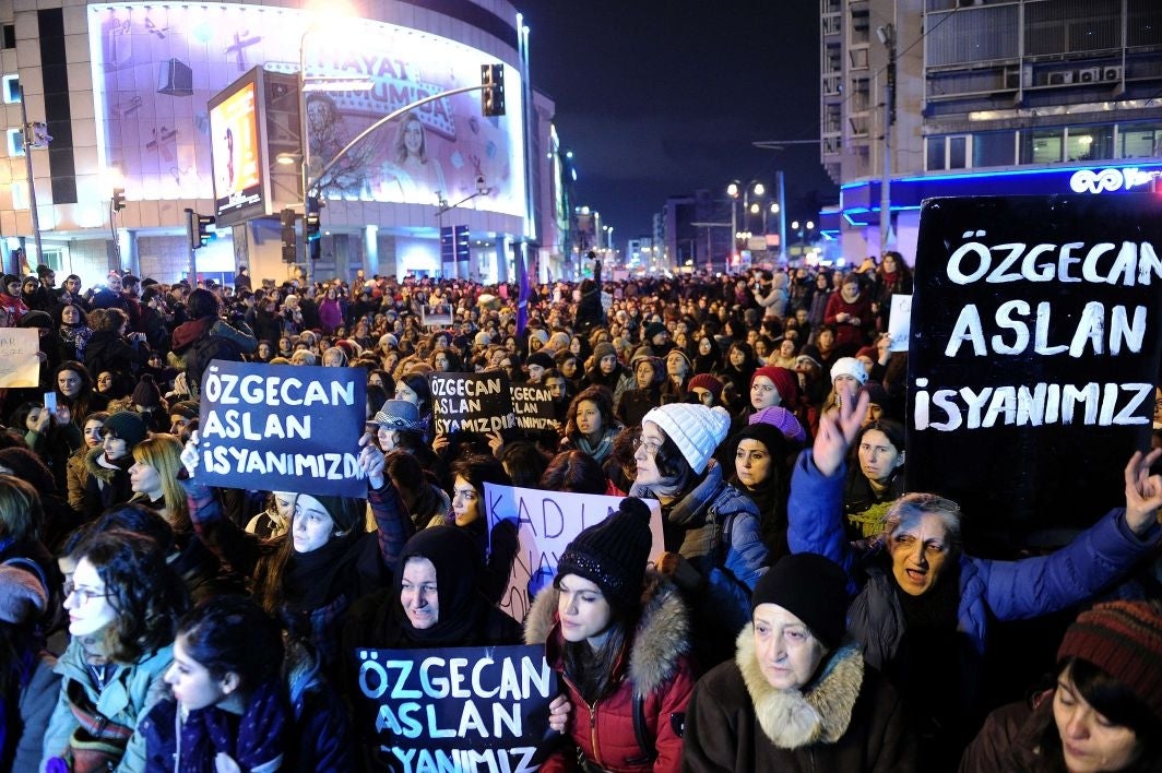 Women shout slogans and hold placards reading "Ozgecan Aslan is our rebellion" during a demostration in Istanbul