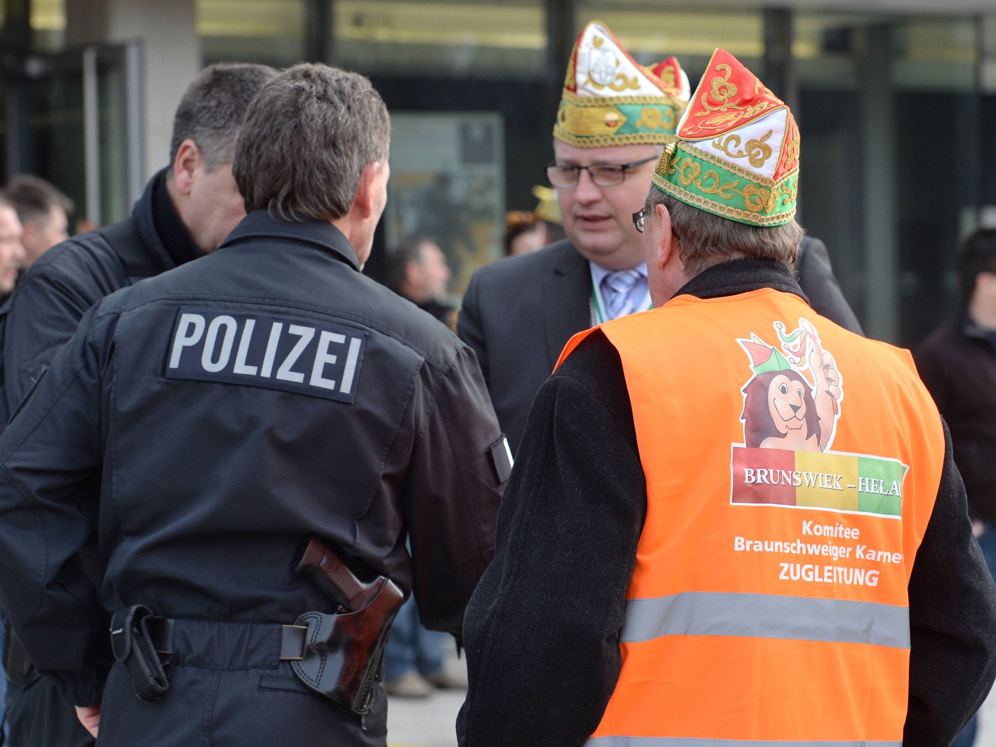 Carnival parade organizers and police discuss in Braunschweig, Germany, Sunday, Feb. 15, 2015. Police in Braunschweig cancelled a popular carnival street parade because of fears of an imminent Islamist terror attack.