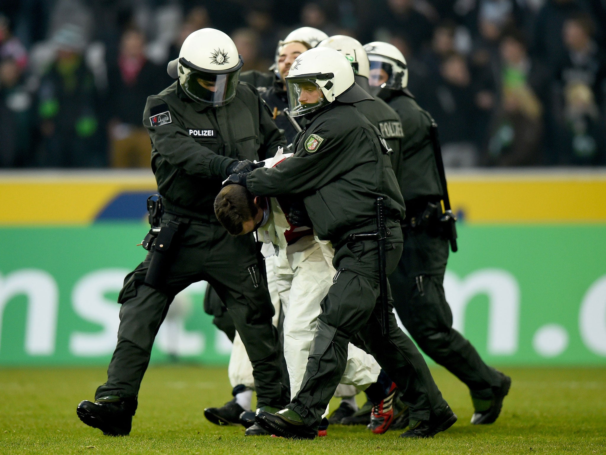 German police apprehend a boiler-suited Cologne fan