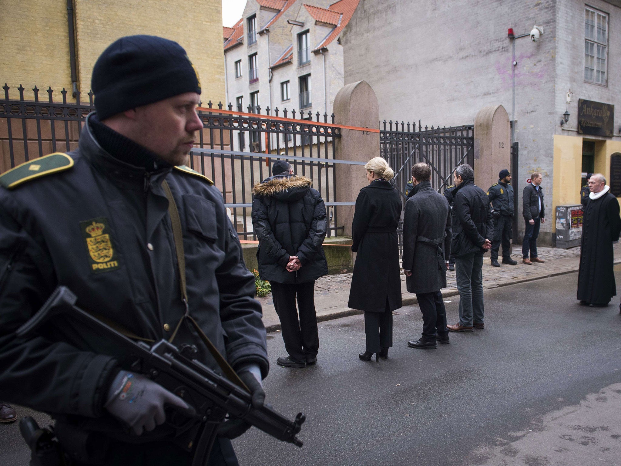 Danish Prime Minister Helle Thorning-Schmidt, third left, and Jewish community leaders pay their respects outside the synagogue in Krystalgade