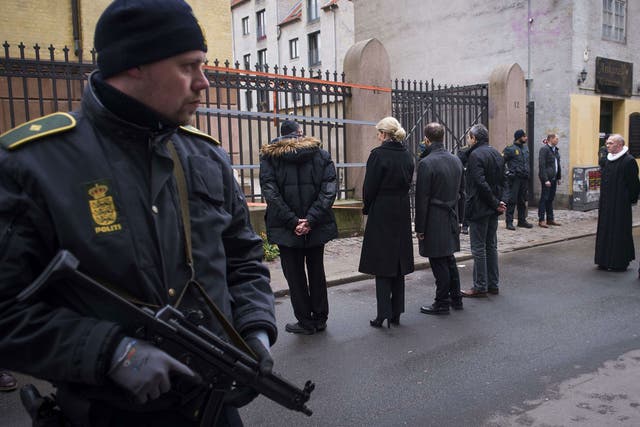 Danish Prime Minister Helle Thorning-Schmidt, third left, and Jewish community leaders pay their respects outside the synagogue in Krystalgade