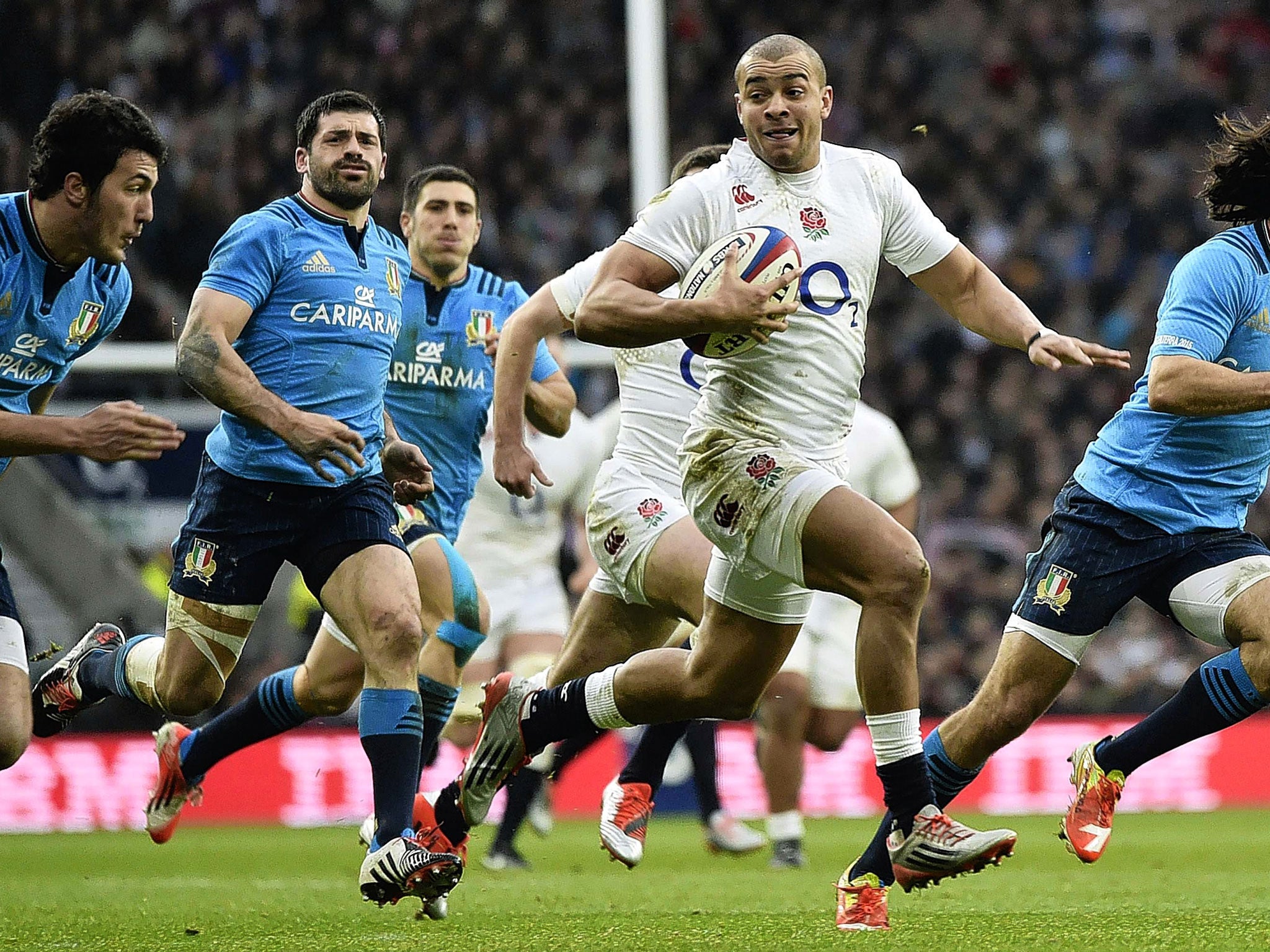Jonathan Joseph breaks through the Italian defence to score the first of his two tries for England on Saturday (Reuters)