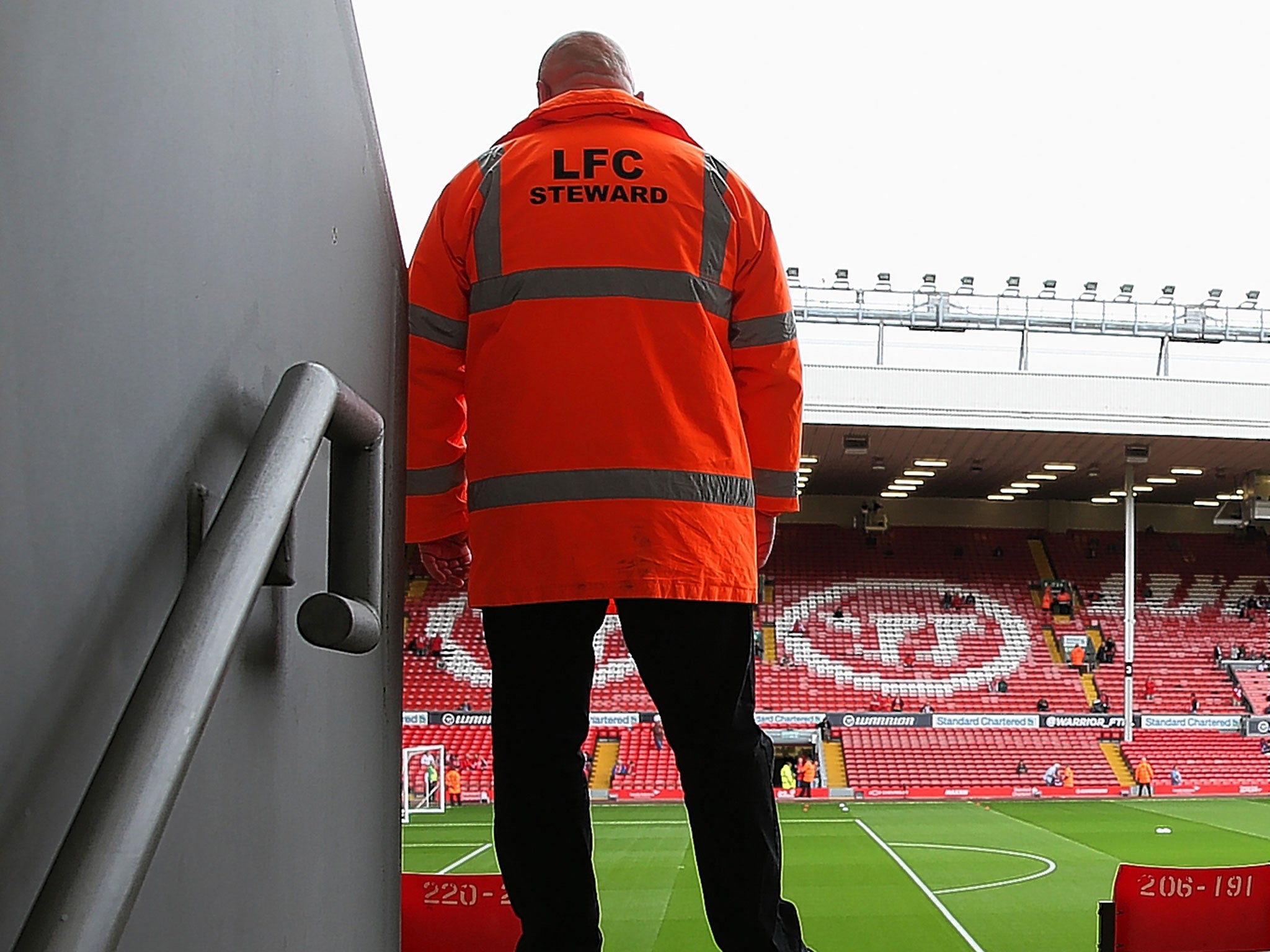 A steward guards an exit at Anfield