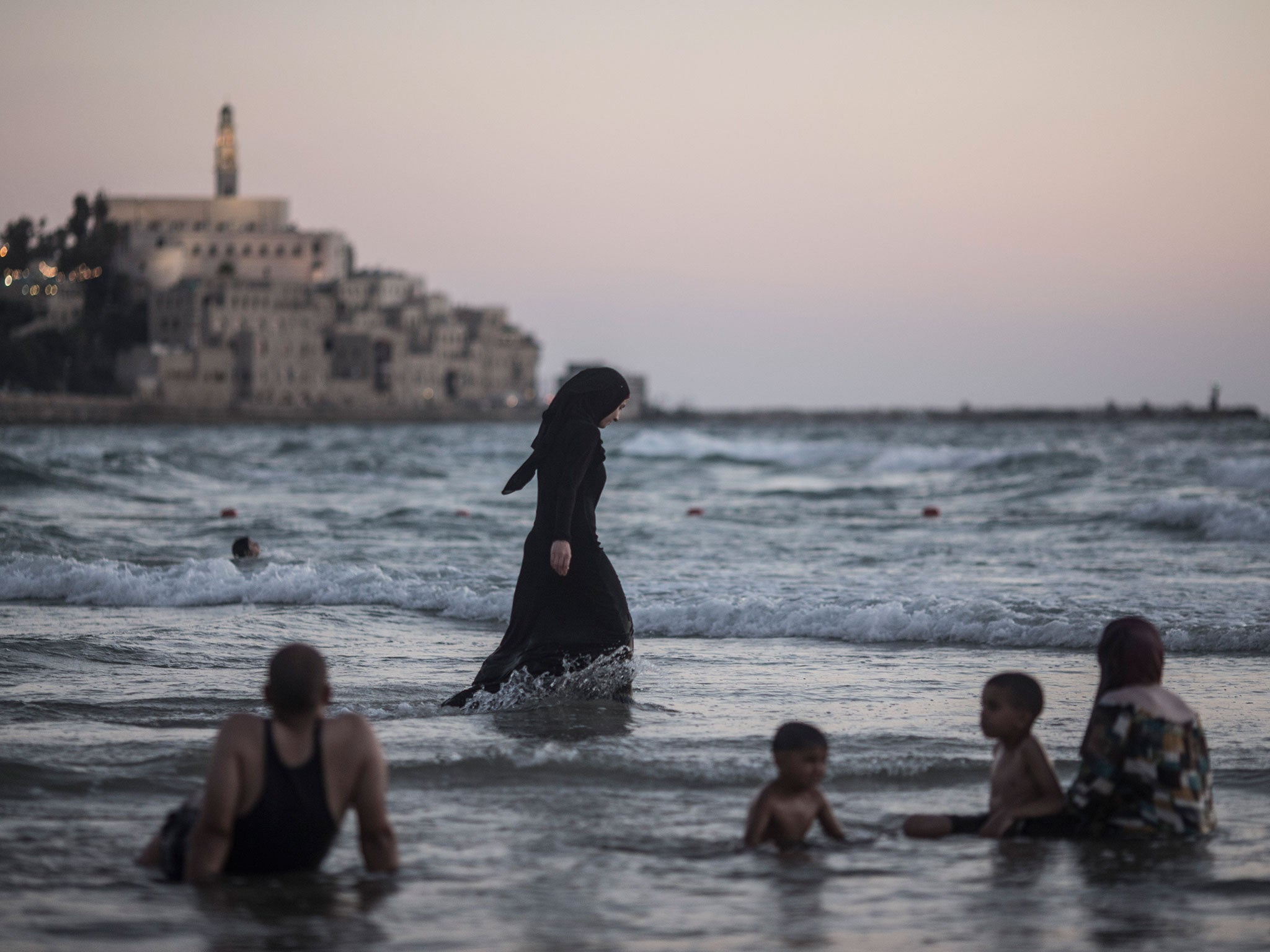Arab Muslims splash around in the Mediterranean near Tel Aviv, Israel. The pact means that Israeli Arabs could hold the balance of power after next month’s election