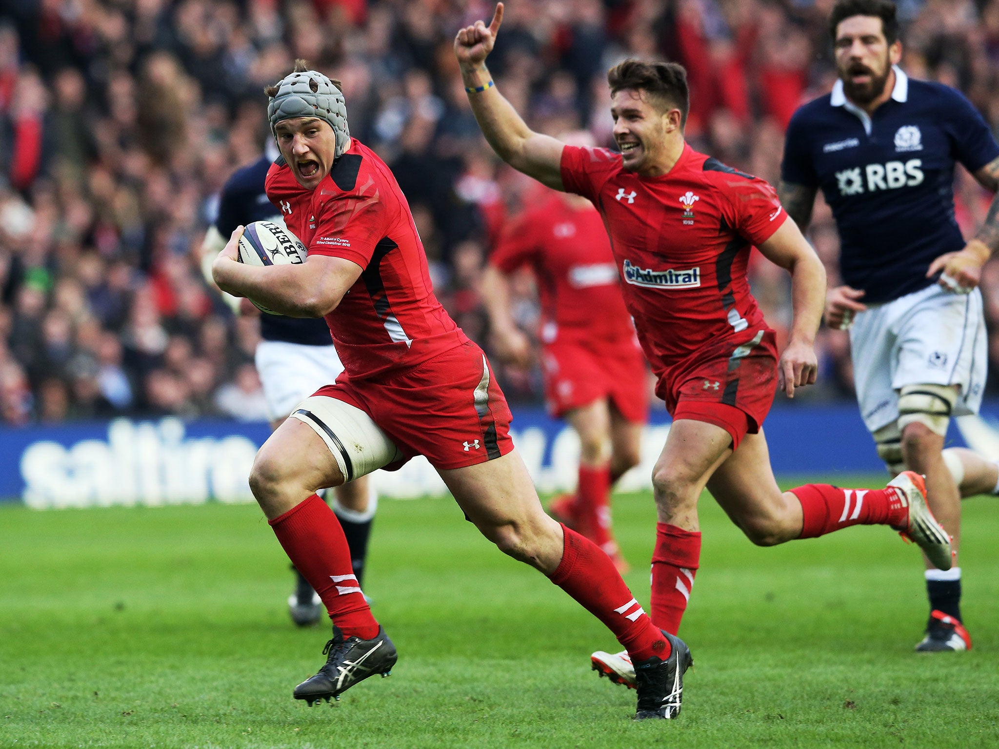 Jonathan Davies, of Wales, scores his team’s second try as team-mate Rhys Webb celebrates
