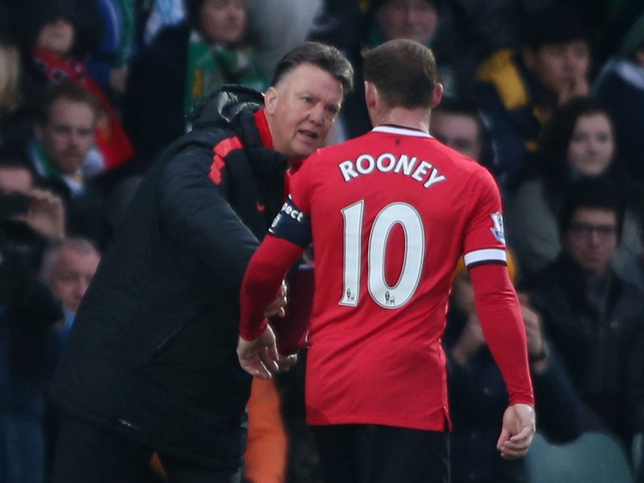 Louis van Gaal talks tactics with Wayne Rooney, who is very happy, says his manager, despite playing out of position