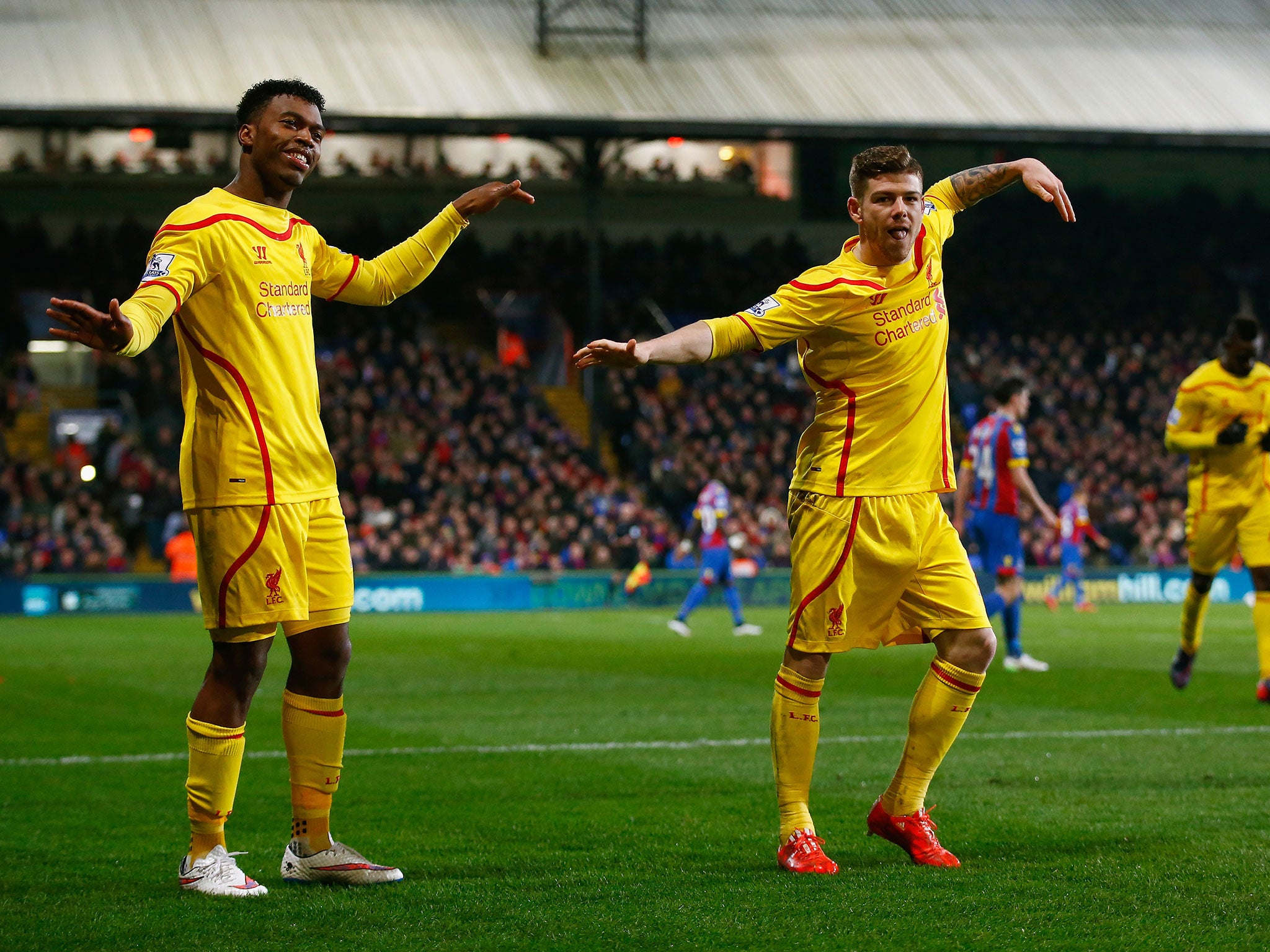 Daniel Sturridge, left, celebrates with Alberto Moreno after scoring Liverpool’s equaliser at Crystal Palace
