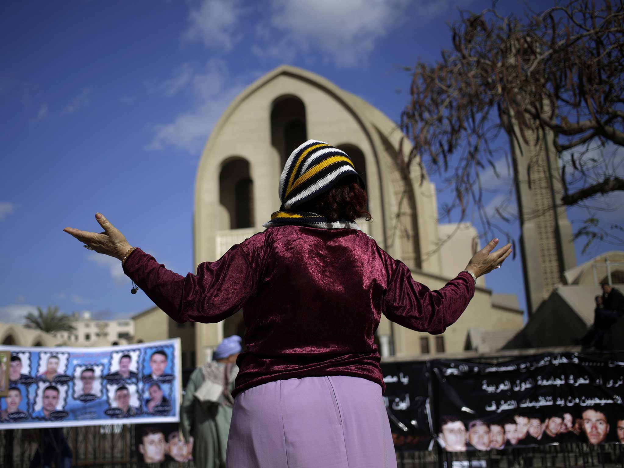 A Coptic Christian woman prays for the release of 21 Coptic Egyptian men