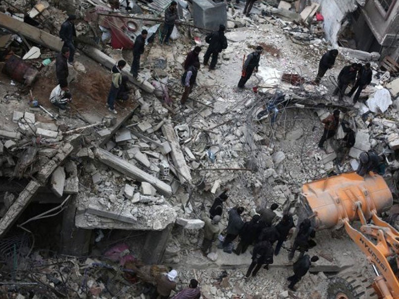 Syrian civilians search for survivors at the site of reported air strikes by regime forces in Douma in February