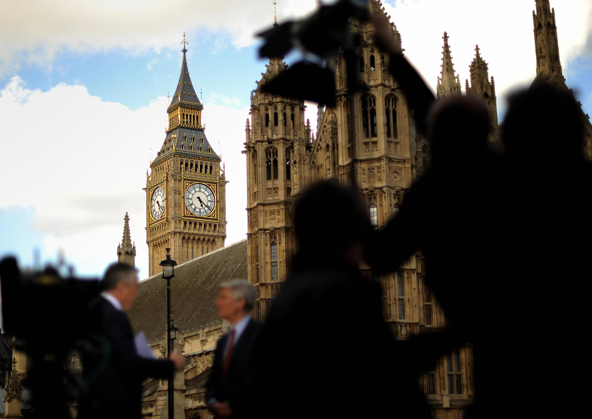 Television media gather outside Parliament following a high profile resignation from the House of Commons