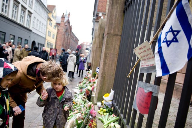 Tributes outside the synagogue where Dan Uzan was killed on Sunday in Copenhagen 