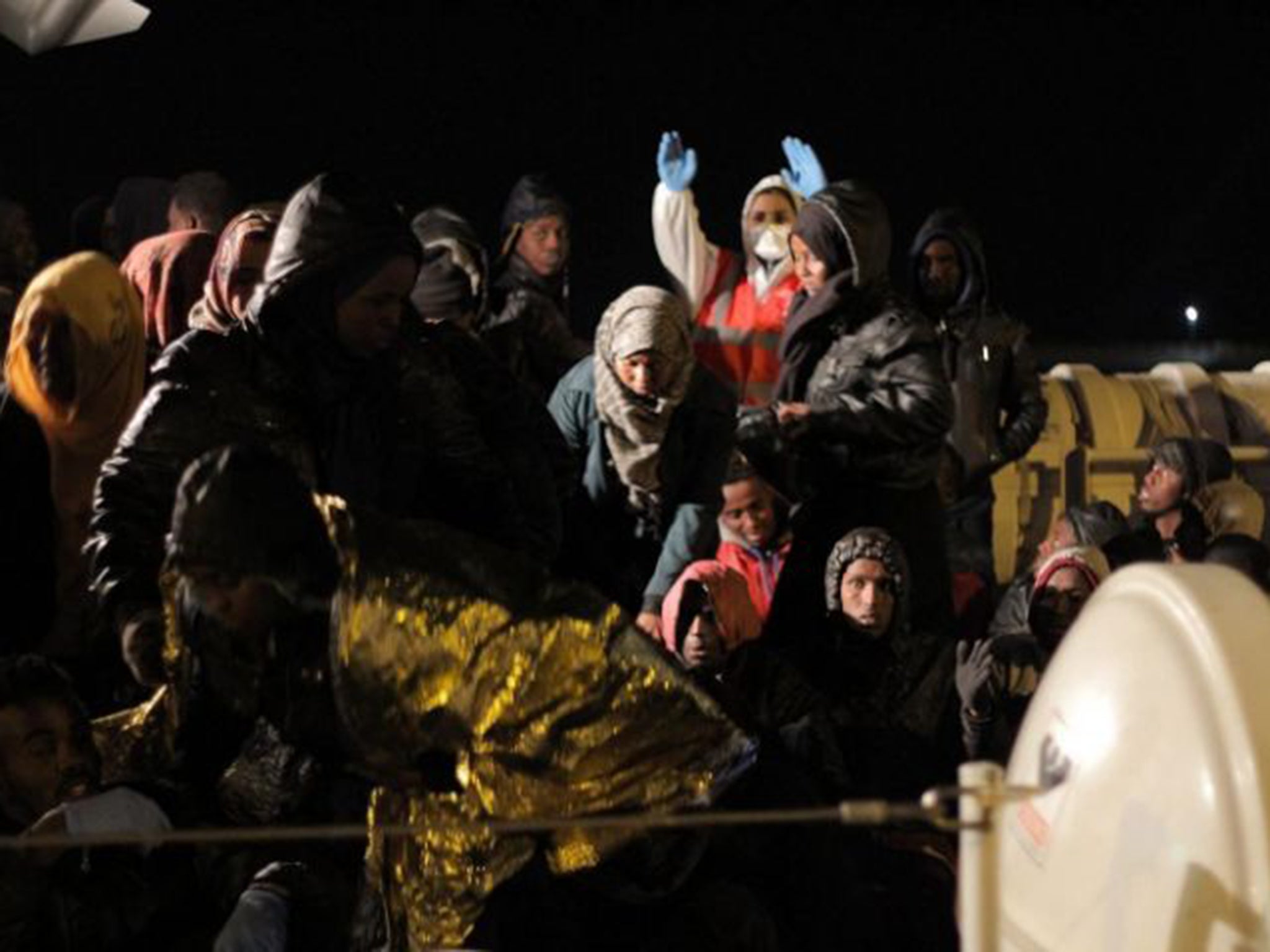 Migrants rescued by the Italian coastguard disembarking in Agrigento province, Sicily, on Monday