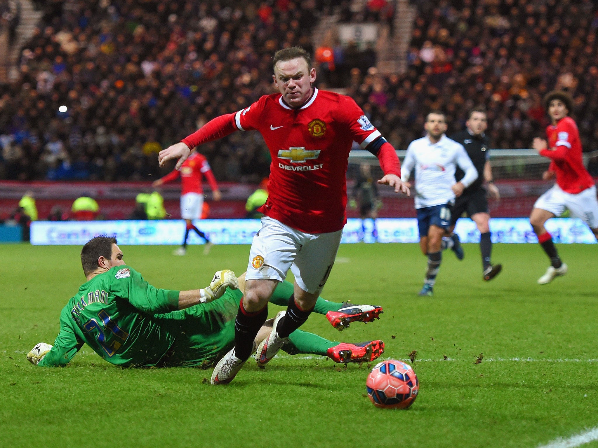Wayne Rooney wins a penalty after going down under the challenge of Thorsten Stuckmann