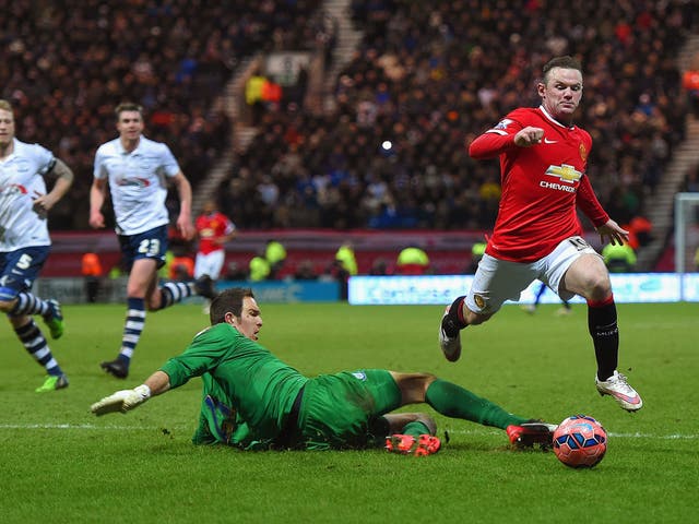 Wayne Rooney goes down after being challenged by goalkeeper Thorsten Stuckmann