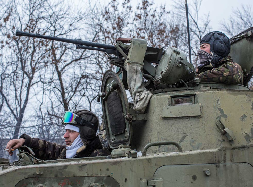 Ukrainian soldiers prepare to drive in the direction of the embattled town of Debaltseve on 16 February 
