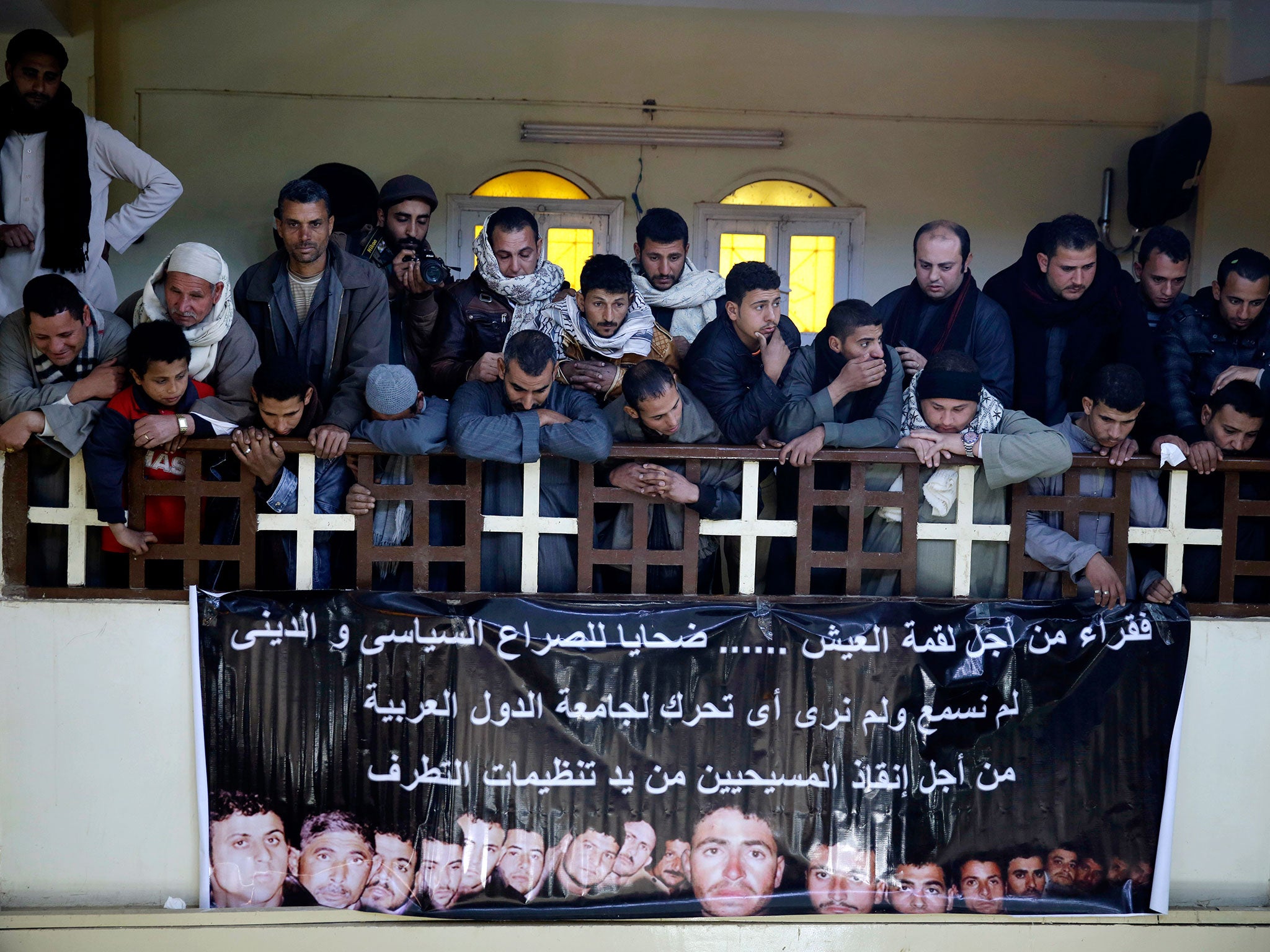 Men mourn over Egyptian Coptic Christians who were captured in Libya and killed by Isis