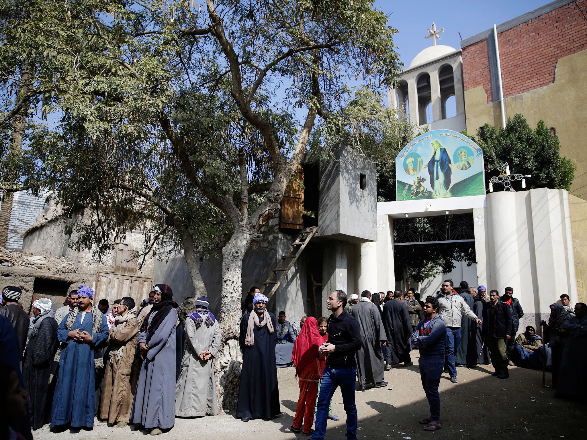 Men mourn over Egyptian Coptic Christians who were killed by Isis militants