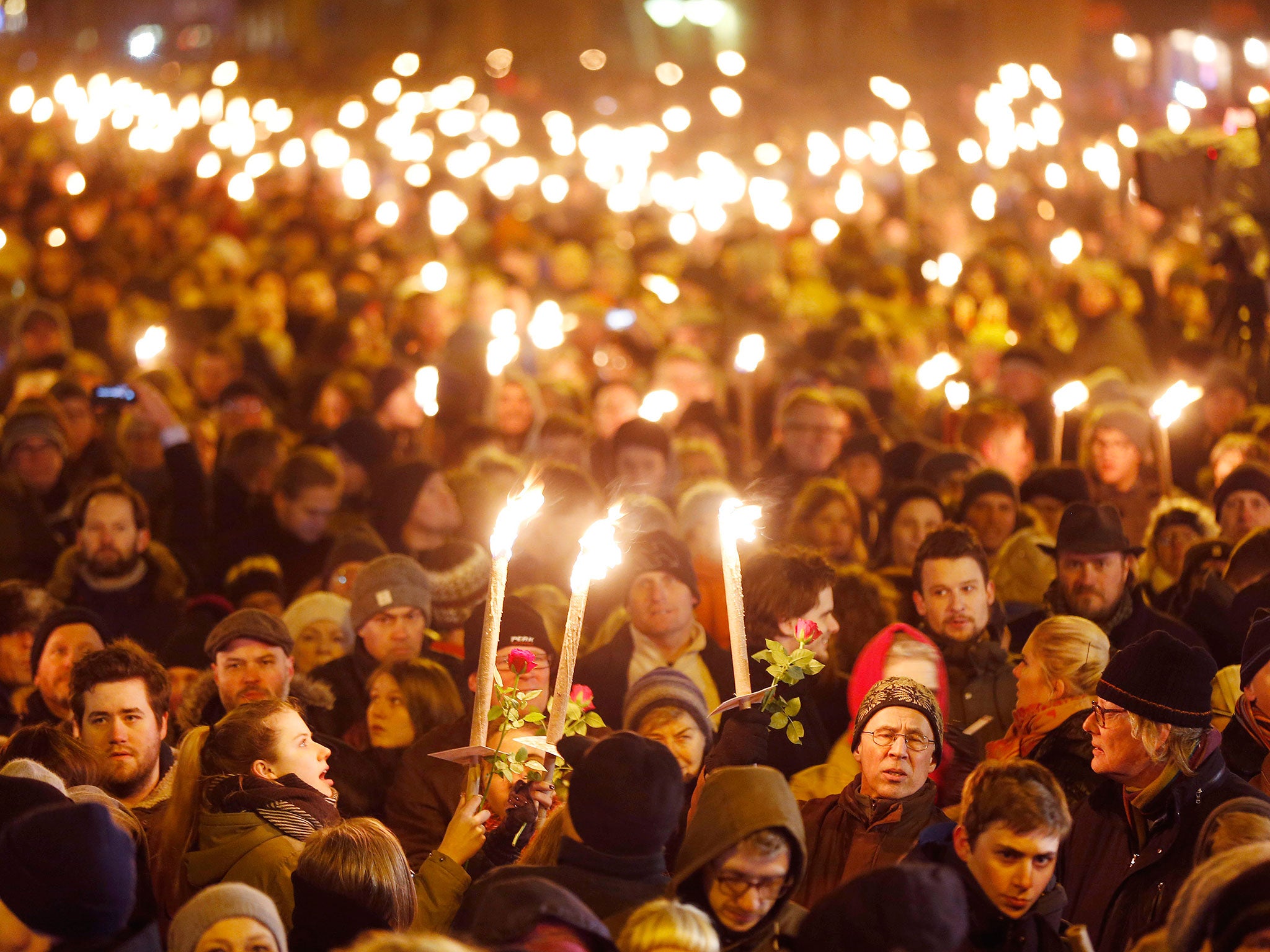 Hundreds of people gather for a vigil near the cultural club, after the slain gunman killed two people in Copenhagen