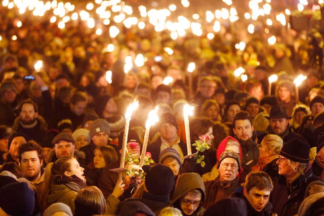 Hundreds of people gather for a vigil near the cultural club, after the slain gunman killed two people in Copenhagen