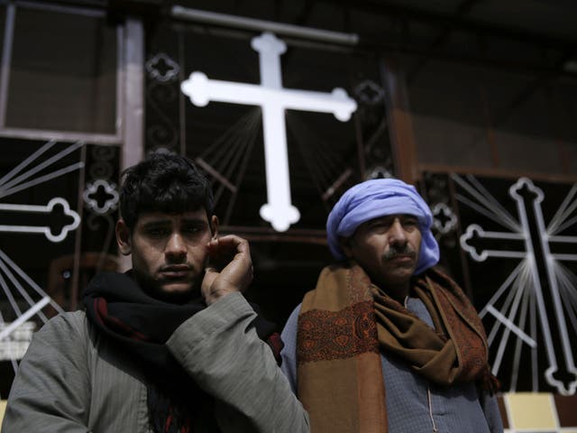 Men mourn Egyptian Coptic Christians captured in Libya and killed by Isis-affiliated militants, at the Virgin Mary Church in the village of el-Aour