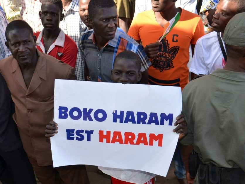 A child holds a sign reading 'Boko Haram is haram' during a protest against deadly raids by Boko Haram in Niger on February 17, 2015 in Niamey.