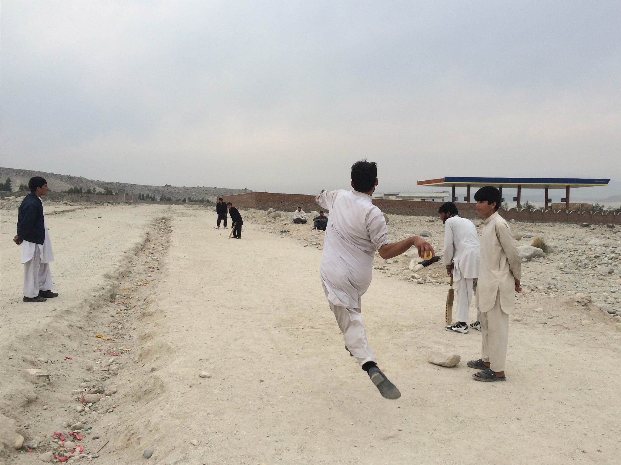 A cricket game on the Kabul-Jalalabad highway. Afghanistan is to play Bangladesh in Australia on Wednesday in the ICC Cricket World Cup