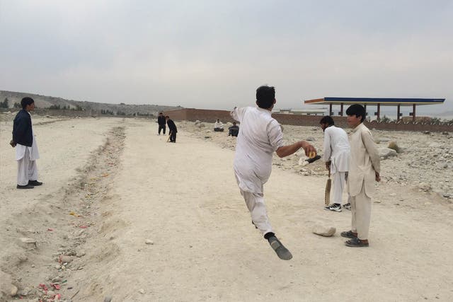 A cricket game on the Kabul-Jalalabad highway. Afghanistan is to play Bangladesh in Australia on Wednesday in the ICC Cricket World Cup