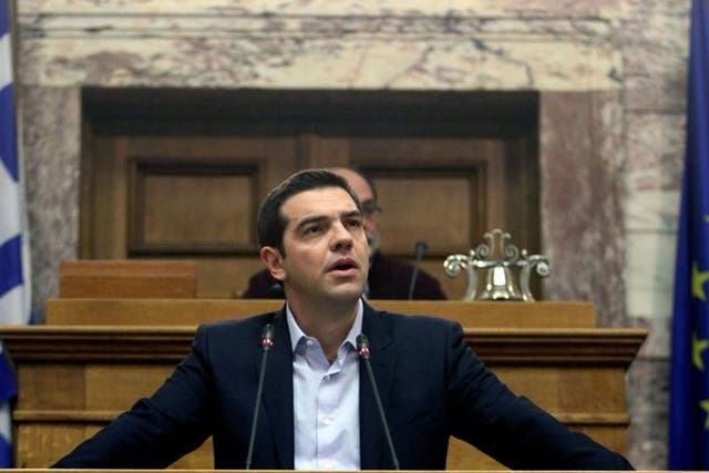 Greek Prime Minister Alexis Tsipras addresses his party lawmakers during a meeting of their parliamentary group at the Parliament in Athens, Greece