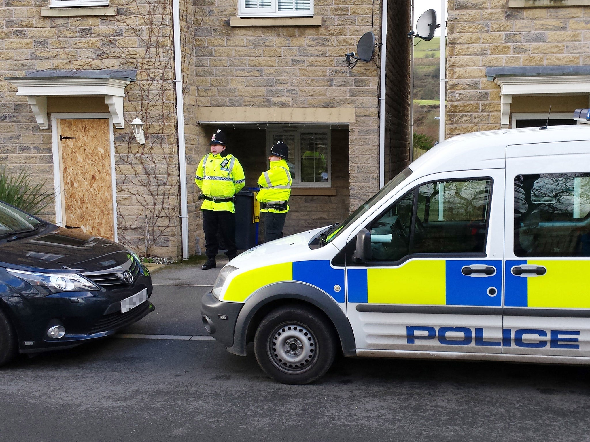Police outside a house in the Mossley area of Tameside following the arrest of two teenagers