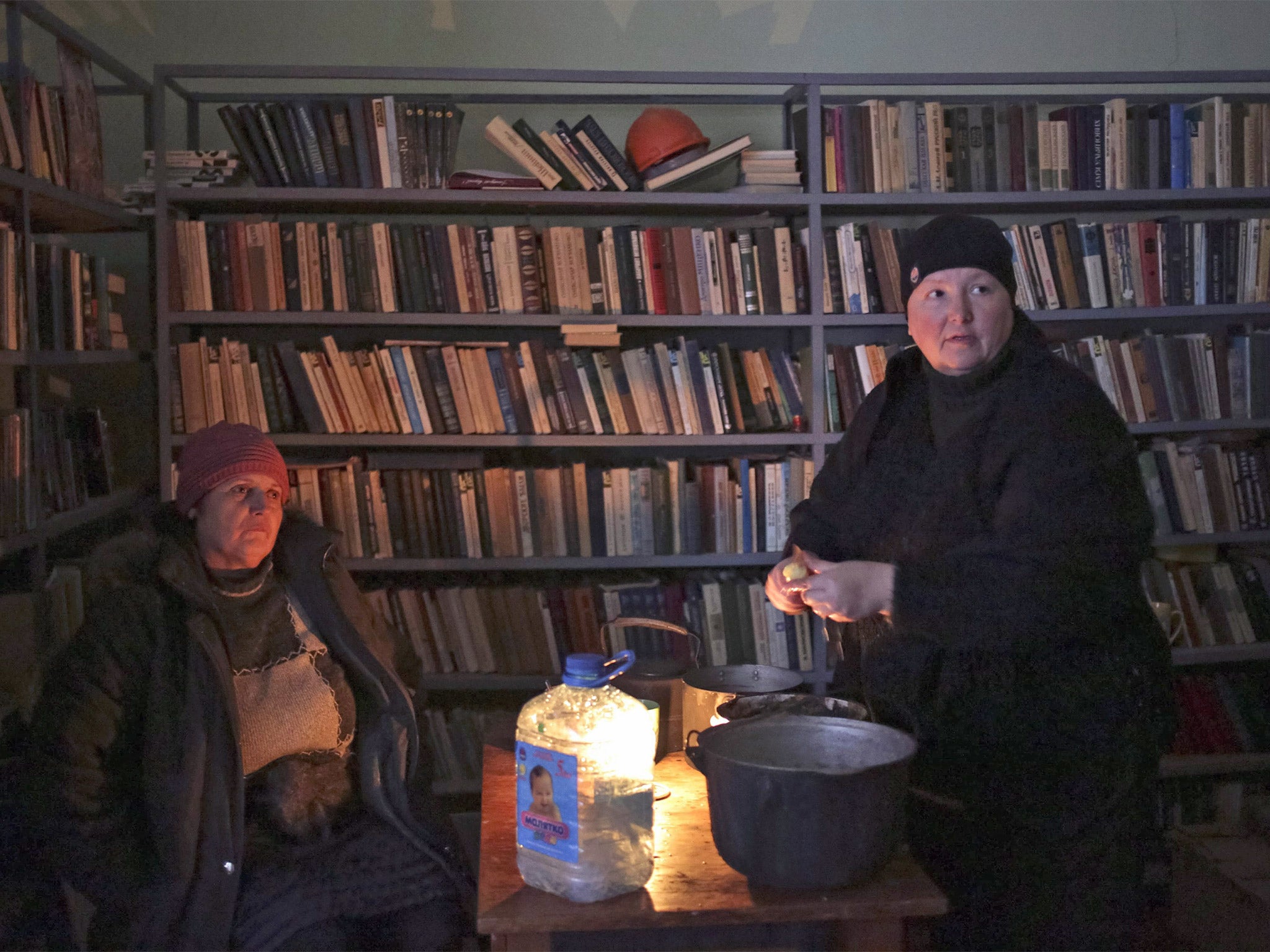 Women cook in the local library, which is being used as a bomb shelter in Mironovka village, near Debaltseve