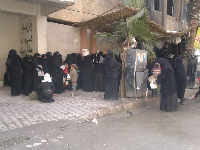 Women living under Isis gather in Raqqa to collect food