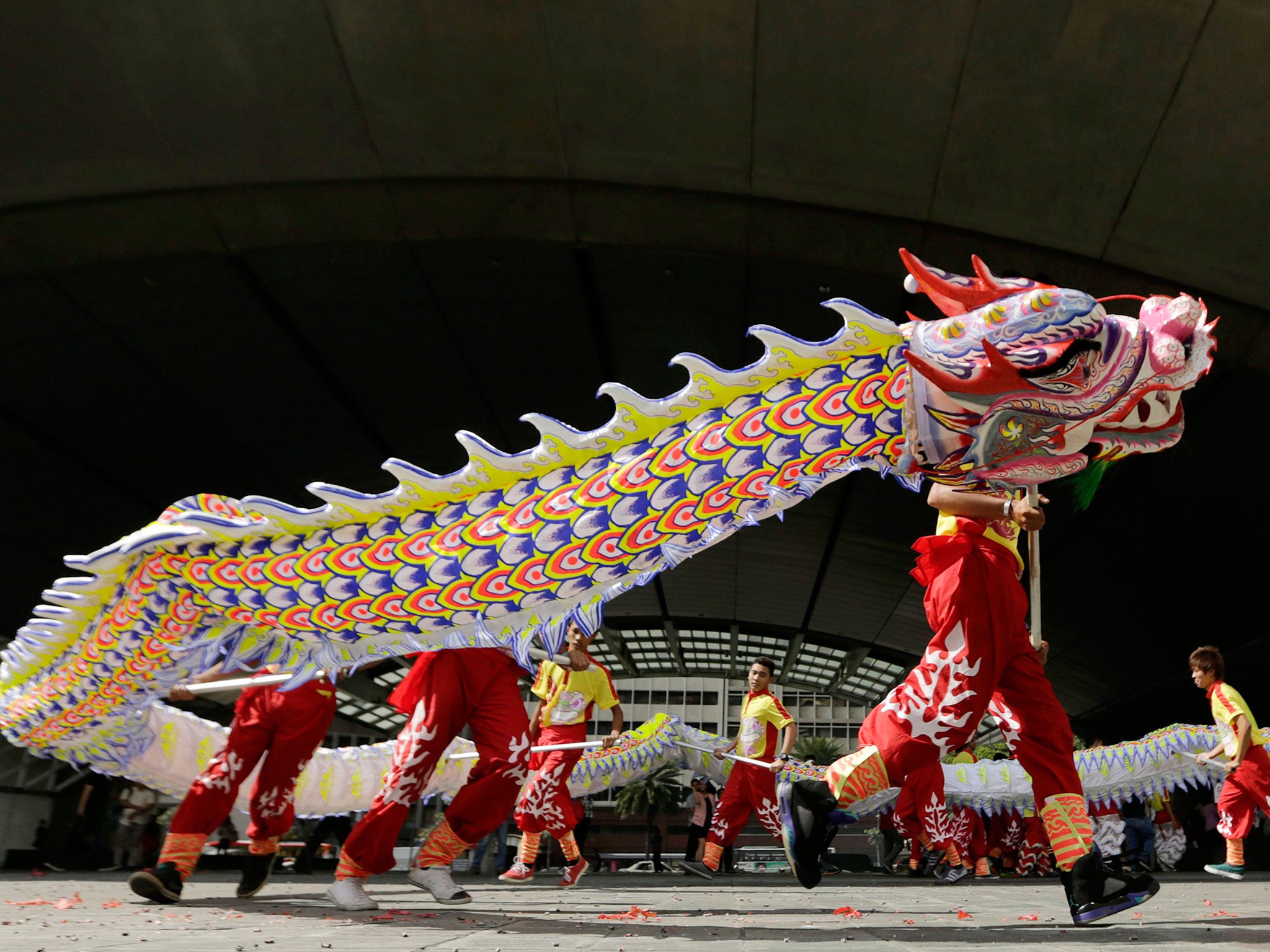 Filipino dancers perform a Dragon Dance on the eve of the Chinese New Year (EPA)