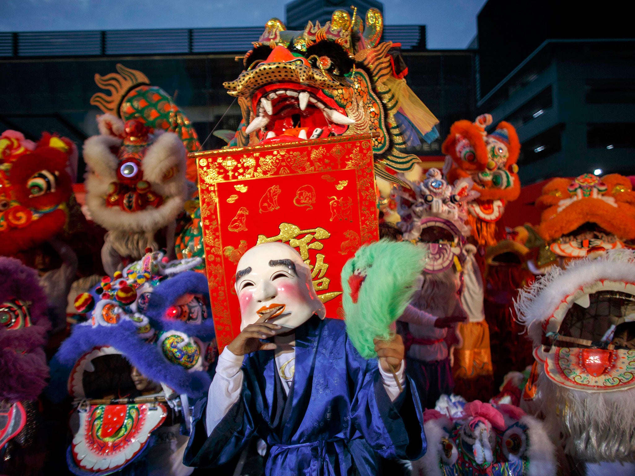 Lion and dragon dancers perform as part of the festive Chinese New Year celebrations in Bangkok's shopping district