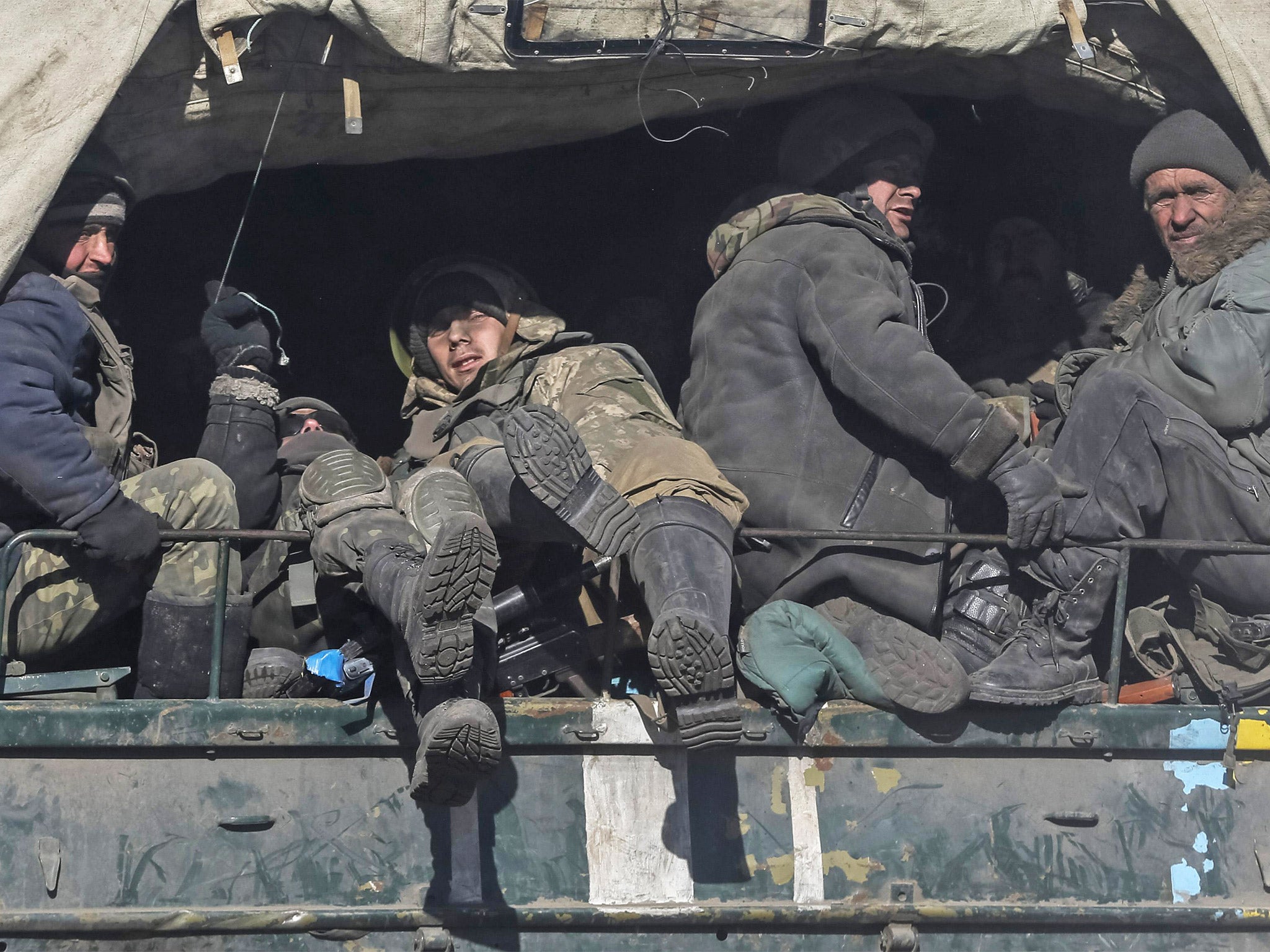 Weary Ukrainian servicemen leave the area around the besieged town of Debaltseve in eastern Ukraine on Wednesday after fierce combat with pro-Russian rebels