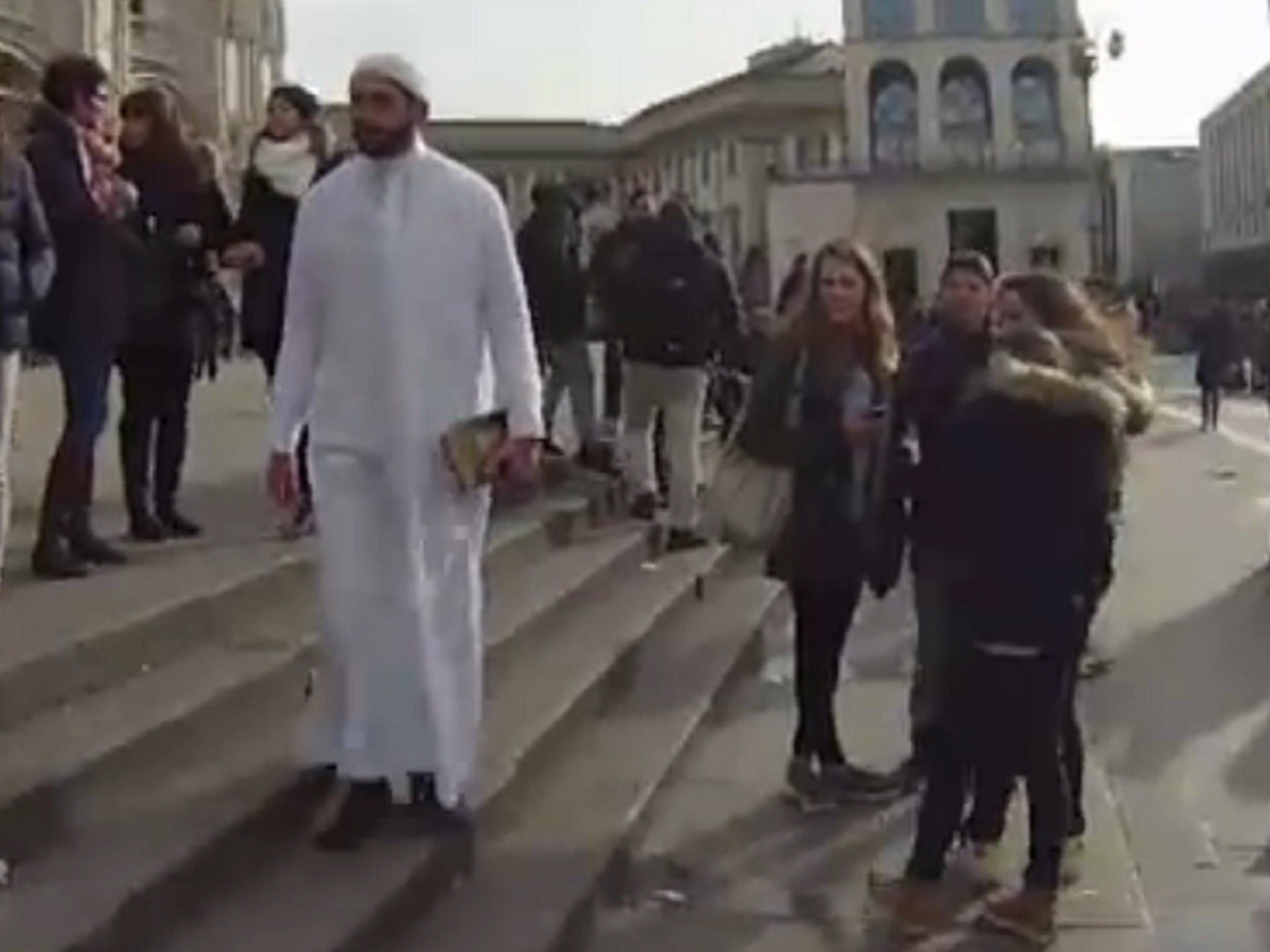 A group of girls stare at Hamdy as he walks past