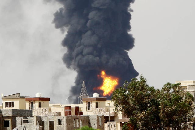 Flames and smoke billows from an oil depot where a huge blaze started following clashes around Tripoli airport last year