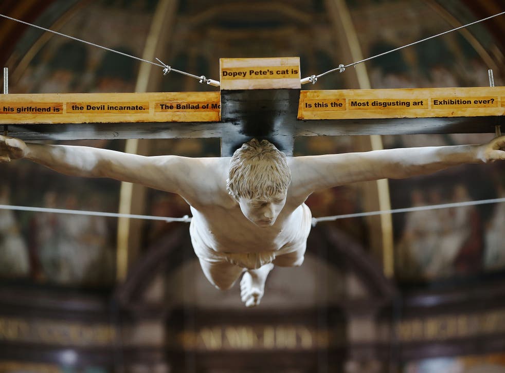 A life-size sculpture by Nick Reynolds depicting singer Pete Doherty on a crucifix hangs in St Marylebone church