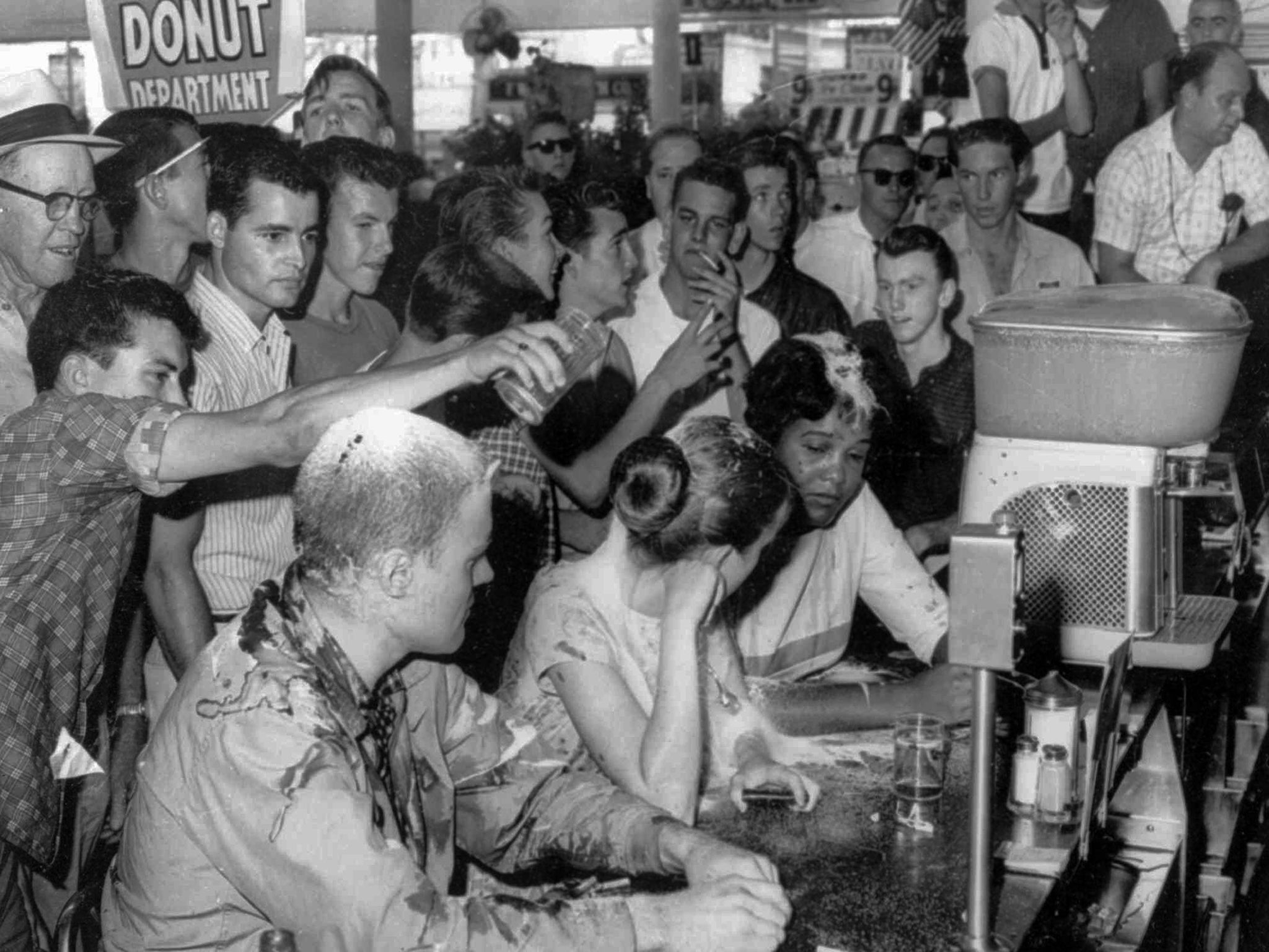 Moody, seated far right, and fellow protestors face a hostile crowd during a sit-in protest against segregation in Jackson, Mississippi in 1963