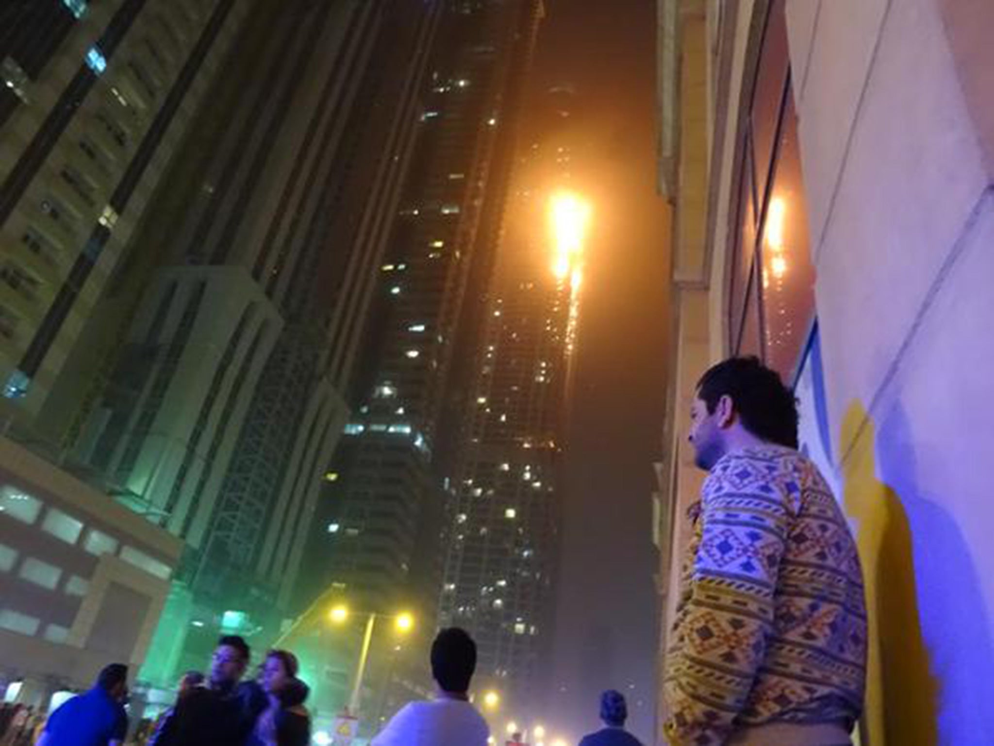 Onlookers watch as flames engulf the Torch in Dubai
