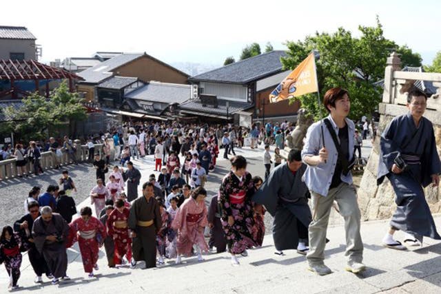 Chinese tourists in hired kimonos at a Kyoto temple 