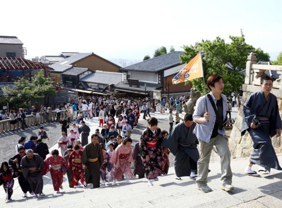 Chinese tourists in hired kimonos at a Kyoto temple 