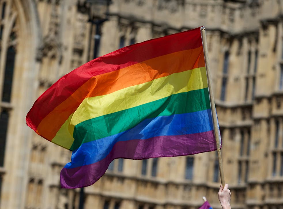 An LGBT rainbow flag flies outside the Palace of Westminster