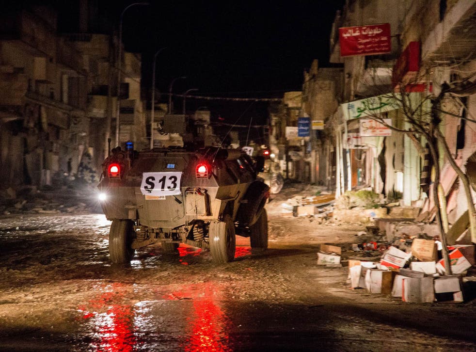 Turkish army vehicles drive in a street of the Syrian town of Kobani on 21 February, 2015
