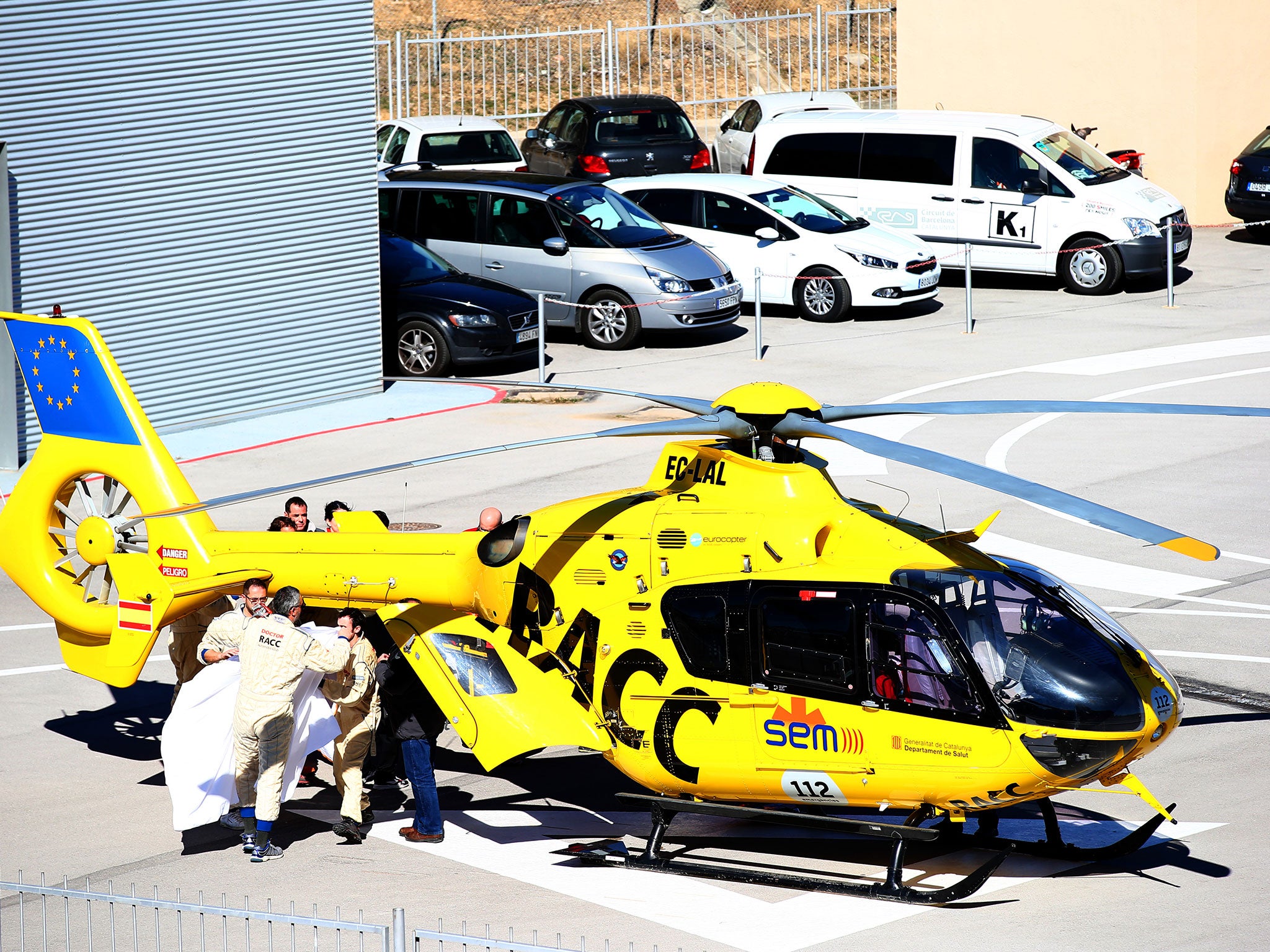 Fernando Alonso is transferred from the medical centre to the helicopter after crashing